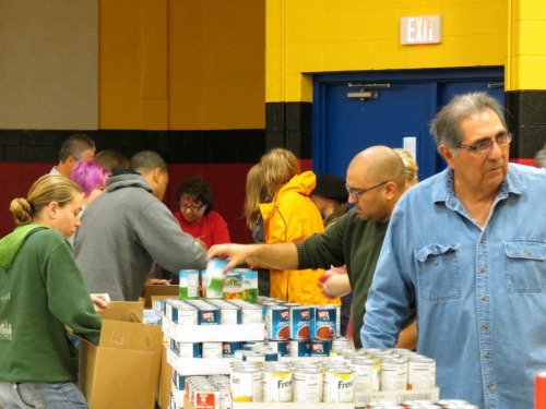 Volunteers pack Weekend Survival Kits for distribution to Lansing school children. Photo provided by Randy A. Bell, Extension Educator, MSU Extension