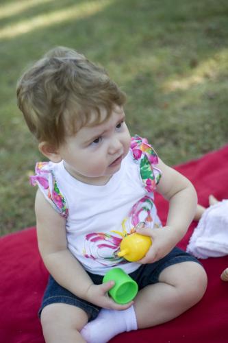 Child sitting on a blanet.