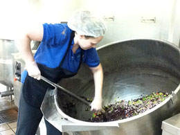 stirring beans in giant bowl