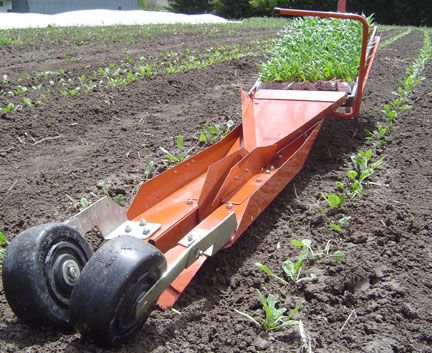 Paper pot transplanter, ready to plant. Photo courtesy of Small Farm Works.